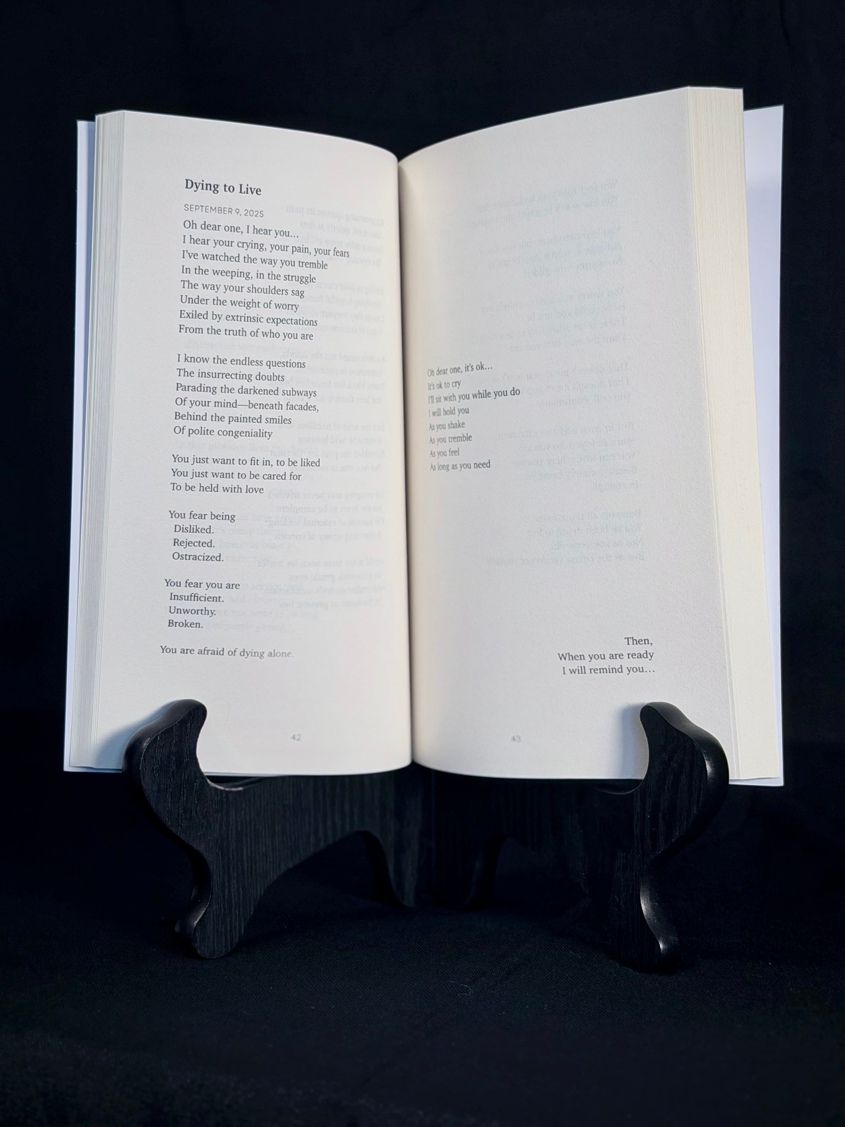 An open copy of Unbecoming displaying the poem Dying to Live across two pages.